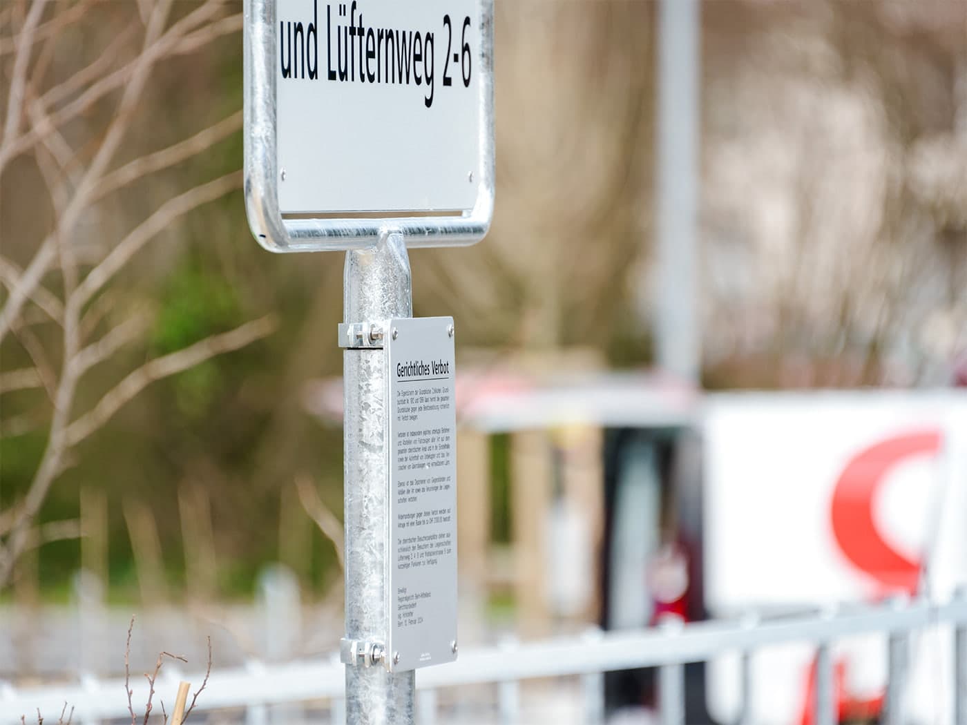Hinweisschild «… und Lüfternweg 2-6» mit richterlichem Verbot am Pfosten